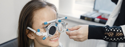 Young patient having a comprehensive eye exam with an optometrist